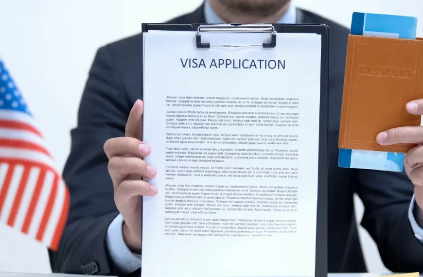 Consul in his office displaying significant documents pertaining to US Visa Application.